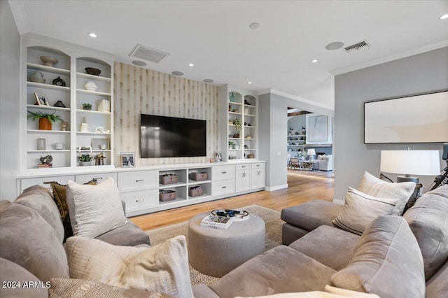 living room with ornamental molding and light wood-type flooring