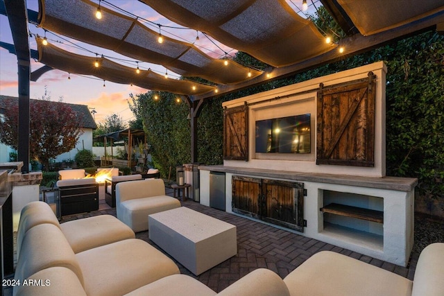 view of patio / terrace with an outdoor kitchen, a pergola, and an outdoor fire pit