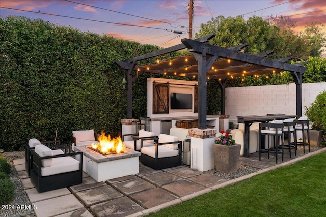 patio terrace at dusk featuring a pergola and a fire pit