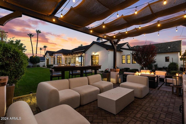 patio terrace at dusk featuring a pergola and an outdoor living space with a fire pit