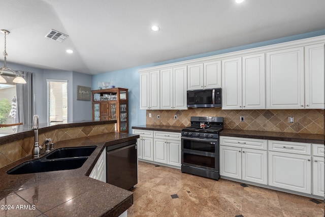 kitchen with hanging light fixtures, stainless steel appliances, sink, white cabinetry, and tasteful backsplash