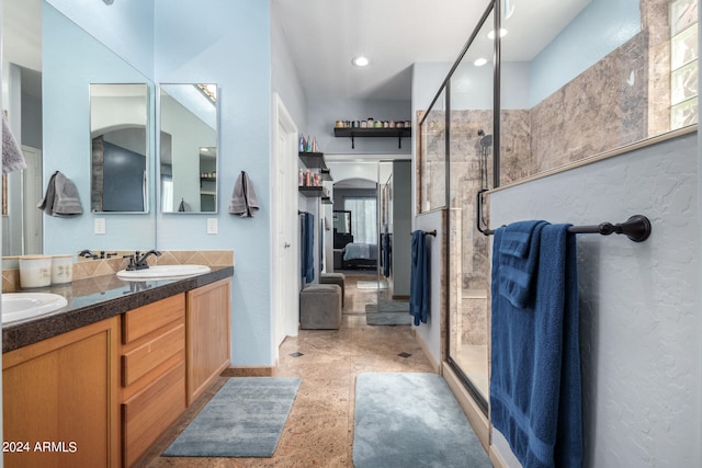 bathroom featuring vanity, walk in shower, and a wealth of natural light