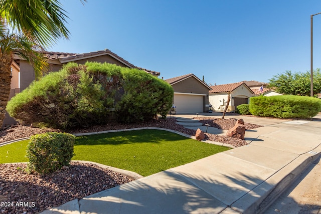 mediterranean / spanish-style home with a front yard and a garage