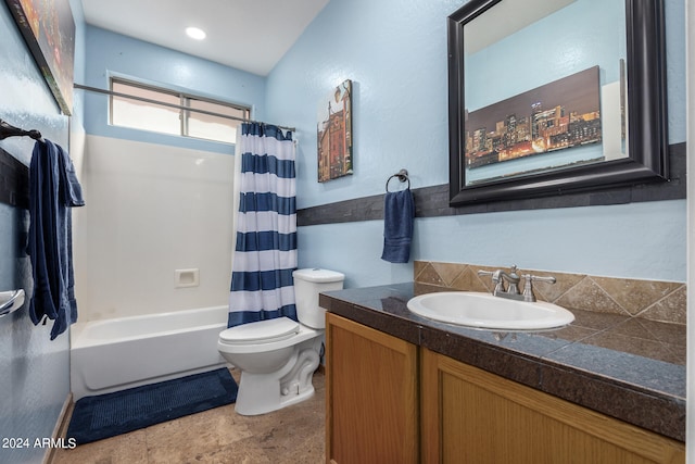 full bathroom with vanity, shower / bath combo with shower curtain, and toilet