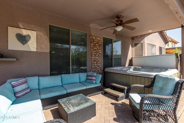 view of patio featuring a hot tub, outdoor lounge area, and ceiling fan