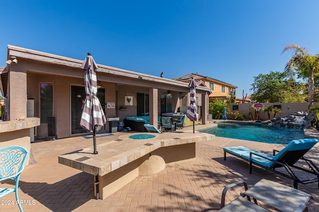 view of pool featuring pool water feature and a patio area