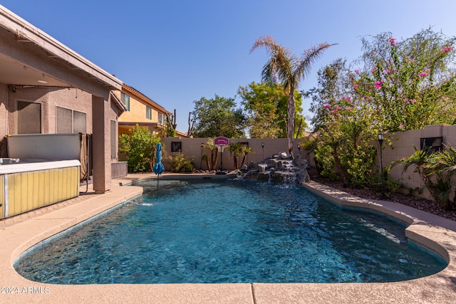 view of pool with pool water feature and a patio