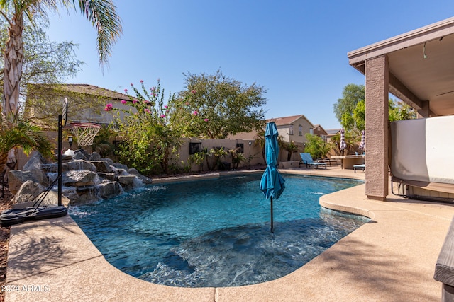 view of swimming pool with a patio area and pool water feature