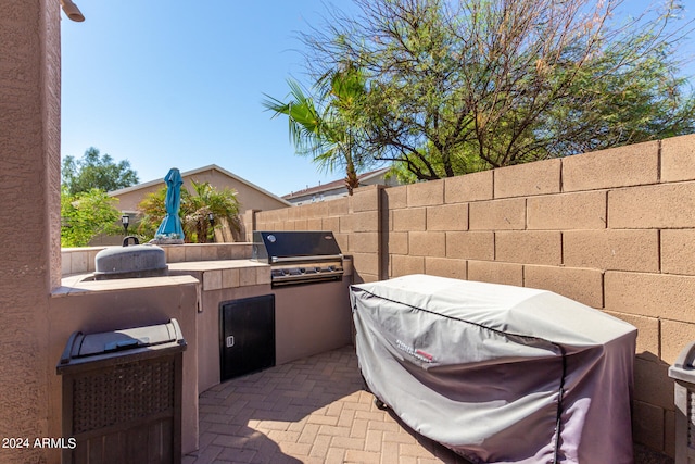 view of patio featuring exterior kitchen and area for grilling