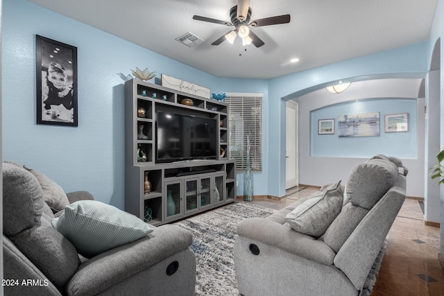 living room featuring light hardwood / wood-style floors and ceiling fan