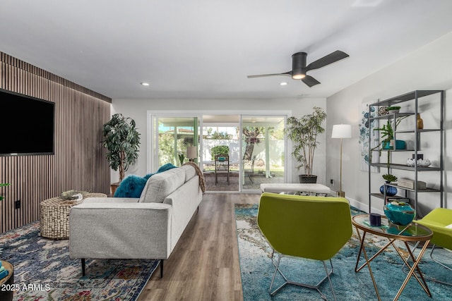 living area with wood finished floors, a ceiling fan, and recessed lighting