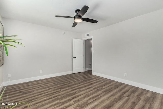 spare room featuring ceiling fan, wood finished floors, and baseboards