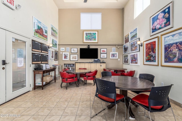 tiled dining area featuring a high ceiling