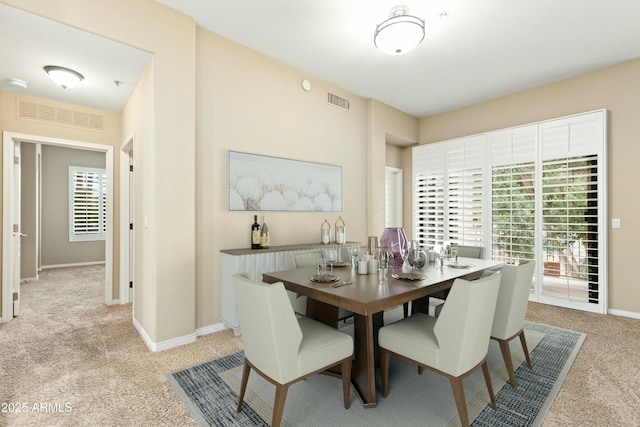 carpeted dining space with plenty of natural light