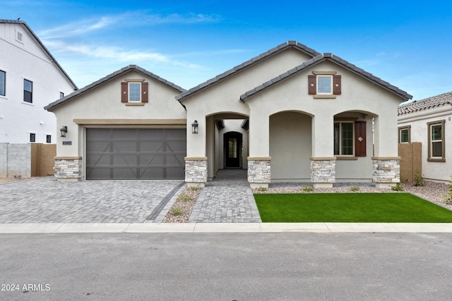 3624 N 59th St, Mesa, AZ 85215 - view of front of house featuring stucco siding, stone siding, decorative driveway, and an attached garage