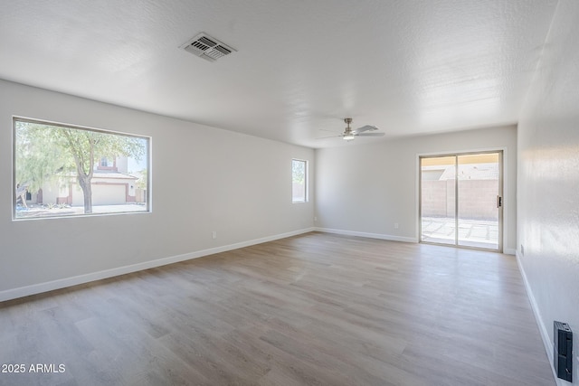 16159 W Maui Ln, Surprise, AZ 85379 - spare room with wood finished floors, a ceiling fan, and baseboards