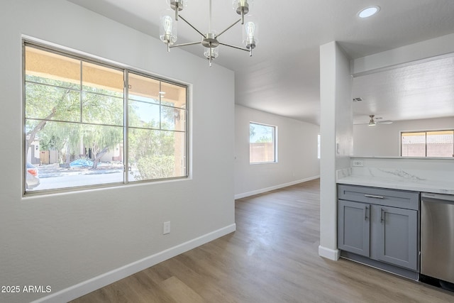 16159 W Maui Ln, Surprise, AZ 85379 - unfurnished dining area featuring a chandelier, light wood-type flooring, baseboards, a ceiling fan, and recessed lighting