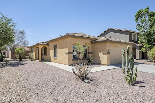 16159 W Maui Ln, Surprise, AZ 85379 - mediterranean / spanish-style home featuring stucco siding, an attached garage, a tiled roof, and concrete driveway