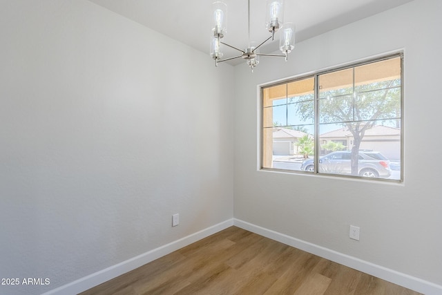 16159 W Maui Ln, Surprise, AZ 85379 - unfurnished room featuring baseboards, light wood finished floors, and a chandelier