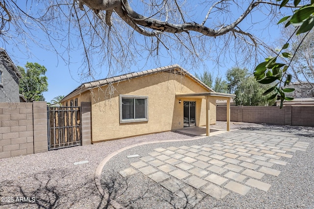 16159 W Maui Ln, Surprise, AZ 85379 - rear view of property with stucco siding, a gate, a fenced backyard, and a patio