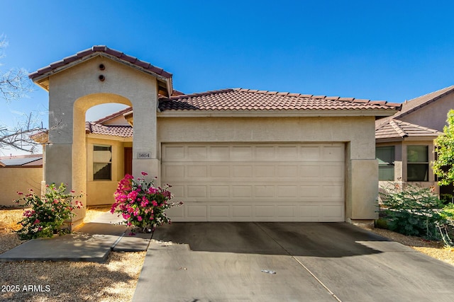 5654 W Vineyard Rd, Laveen, AZ 85339 - view of front of home with an attached garage, a tile roof, stucco siding, and driveway