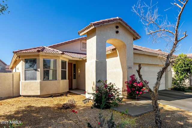 5654 W Vineyard Rd, Laveen, AZ 85339 - mediterranean / spanish-style house featuring a tiled roof, an attached garage, and stucco siding