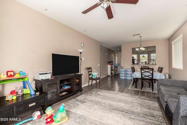 5654 W Vineyard Rd, Laveen, AZ 85339 - living room featuring wood finished floors, a ceiling fan, and a chandelier