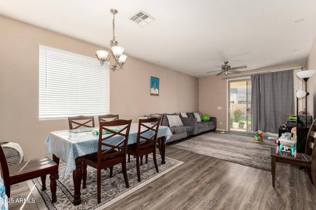 5654 W Vineyard Rd, Laveen, AZ 85339 - dining area featuring a chandelier, wood finished floors, and ceiling fan