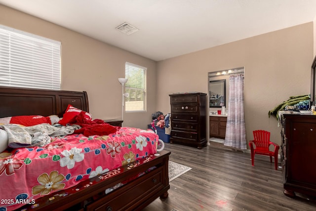 5654 W Vineyard Rd, Laveen, AZ 85339 - bedroom featuring dark wood-style floors and ensuite bath