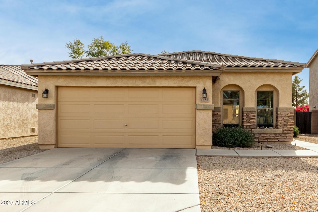 mediterranean / spanish house with a garage