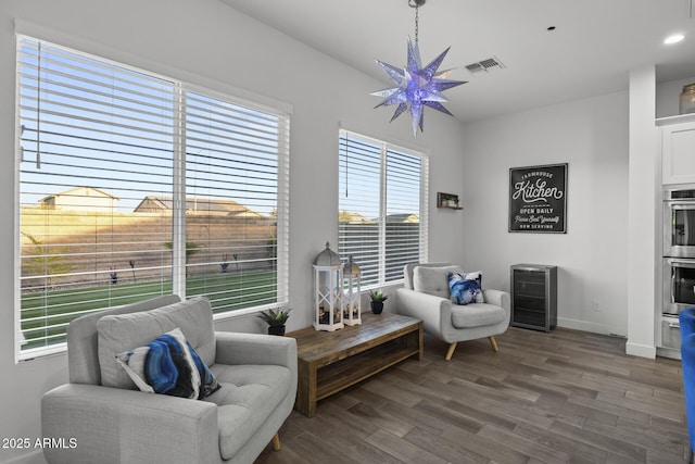 sitting room with dark hardwood / wood-style floors and wine cooler