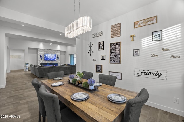 dining space featuring an inviting chandelier and wood-type flooring