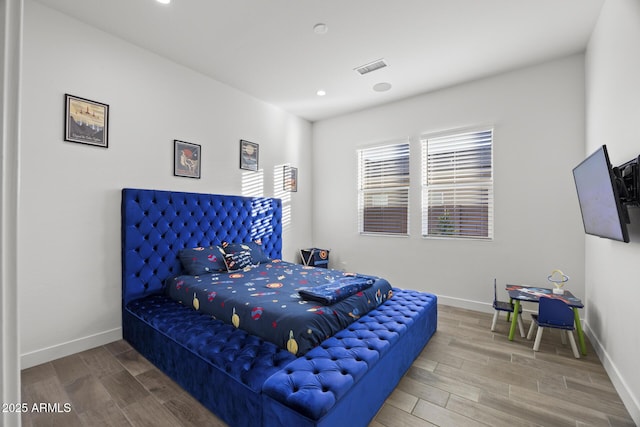 bedroom with hardwood / wood-style floors