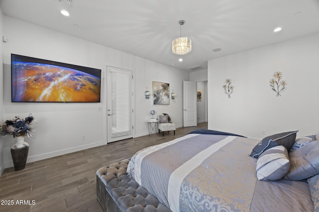 bedroom with a notable chandelier and dark hardwood / wood-style floors