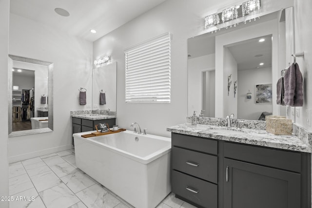 bathroom with vanity and a tub to relax in