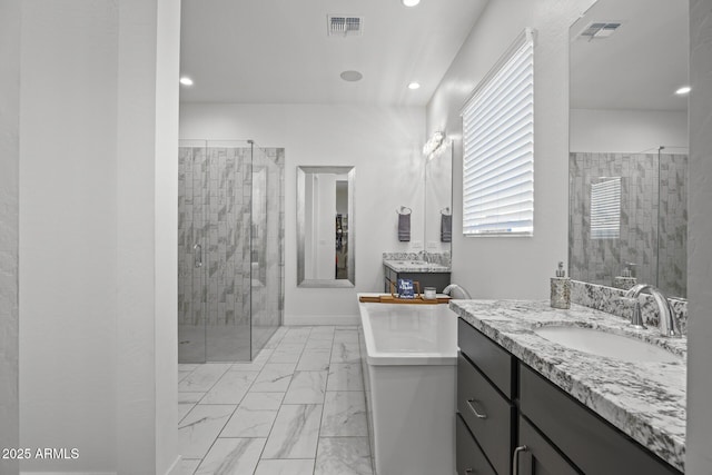 bathroom with vanity and independent shower and bath