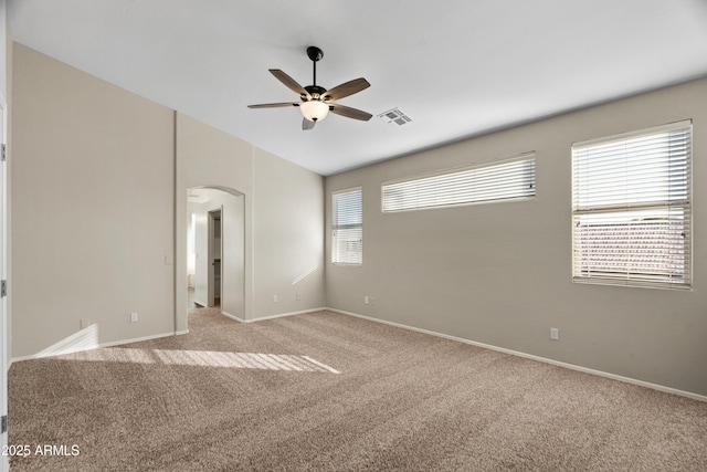 carpeted empty room featuring ceiling fan and vaulted ceiling