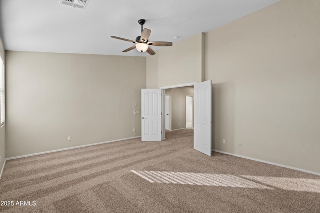 carpeted spare room with ceiling fan