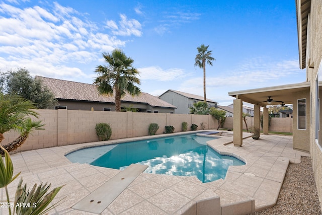 view of swimming pool with ceiling fan and a patio area