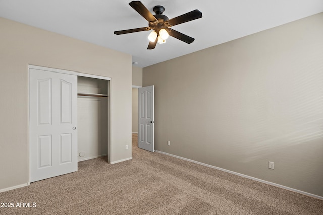 unfurnished bedroom with light colored carpet, a closet, and ceiling fan