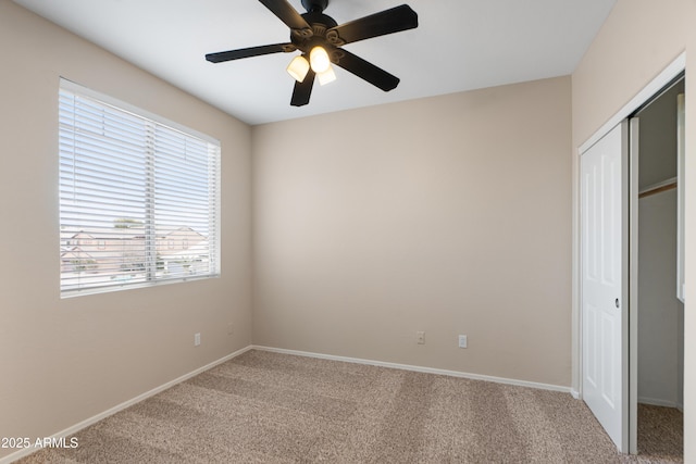 unfurnished bedroom with a closet, ceiling fan, and carpet