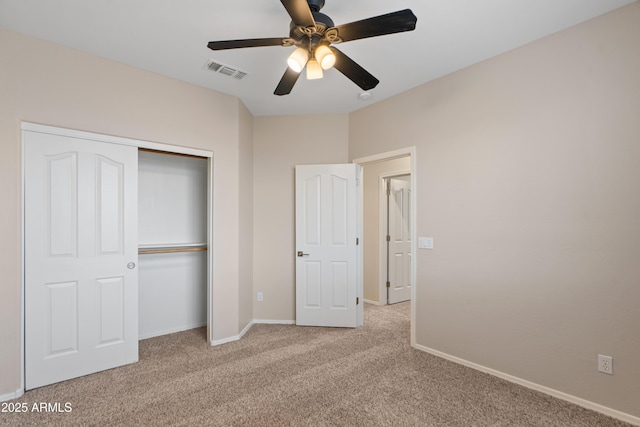 unfurnished bedroom featuring light colored carpet, a closet, and ceiling fan