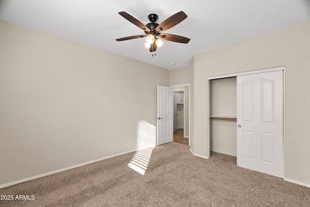 unfurnished bedroom with ceiling fan, light colored carpet, and a closet