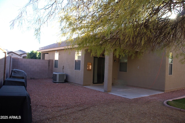 back of property with cooling unit and a patio area