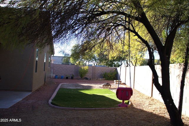 view of yard with a fire pit