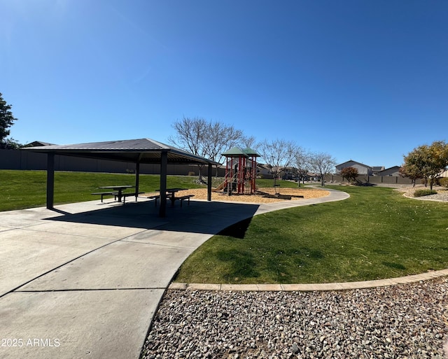 view of property's community with a playground, a gazebo, and a lawn