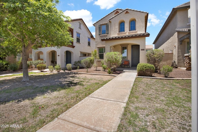 3036 N Acacia Way, Buckeye, AZ 85396 - mediterranean / spanish-style home featuring stucco siding, a tile roof, and a porch