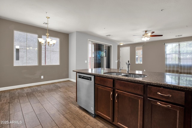 3036 N Acacia Way, Buckeye, AZ 85396 - kitchen featuring dishwasher, dark stone counters, wood finished floors, hanging light fixtures, and a chandelier