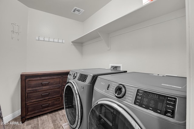 3036 N Acacia Way, Buckeye, AZ 85396 - laundry room with washing machine and clothes dryer and light wood-type flooring
