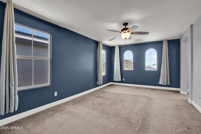 3036 N Acacia Way, Buckeye, AZ 85396 - unfurnished room featuring healthy amount of natural light, ceiling fan, and carpet flooring